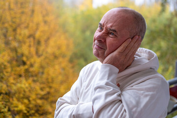 man covering ears with pained expression, Emotional portrait showing discomfort loud noise,...