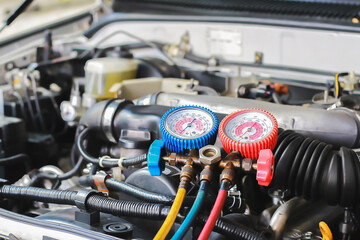 Car air conditioner check service, leak detection, fill refrigerant.Device and meter liquid cooling in the car by specialist technicians. © bancha
