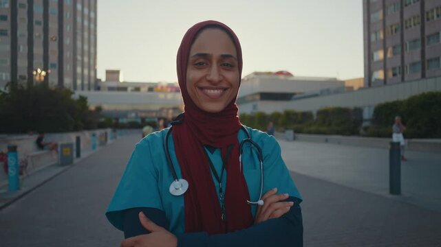 Beautiful arab nurse wearing hijab portrait at the city hospital - Middle eastern adult female working in healthcare clinic	
