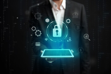 Professional man presenting a digital pad with security symbols in a high-tech environment