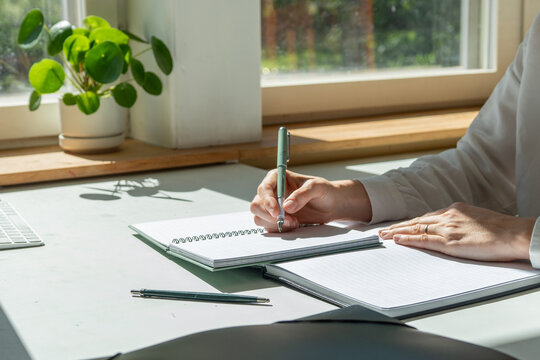 Remote work at home office dest with laptop and notes. 