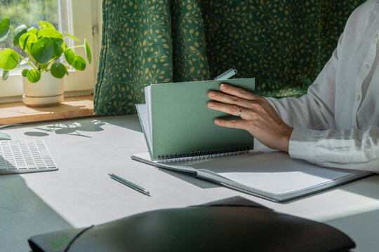 Remote work at home office dest with laptop and notes. 