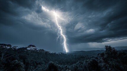 Lightning bolt striking over dense forest under dark stormy clouds with moody blue tones