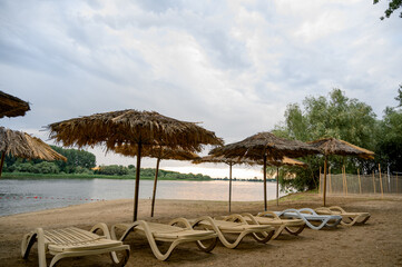 River bank with beach umbrellas and trees