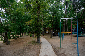 Fototapeta premium Children's playground with a view of the house and slide in the park