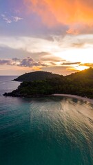 Aerial view of a tropical sunset over a secluded beach
