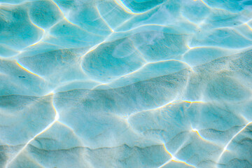 Sunlight shimmering on clear ocean water surface