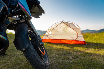 Motorcycle against the backdrop of mountains in the evening, sunset.