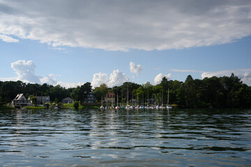 reflection of trees and yachts in lake