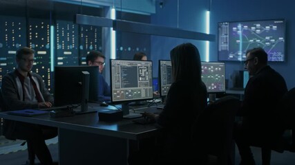 IT Specialists Concentrate on Analyzing Information on their Screens at Their Desks, Working With Multiple Monitors Displaying Technical Data, Code, Visualizations, Operations and System Monitoring  - Powered by Adobe