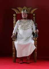 king in white robe on throne
