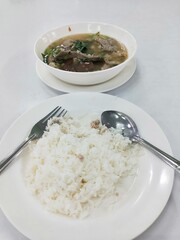 Steamed White Rice with Pork Soup in White Bowl