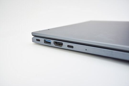 Closed laptop showing side ports including USB, HDMI, and Type-C, concept of connectivity, modern technology, and portable computer design.