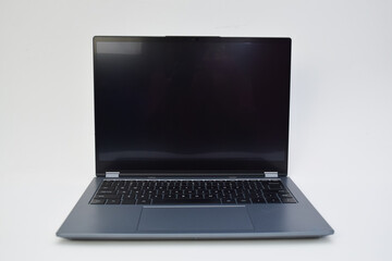 Front view of modern laptop with black screen on white background, concept of digital device, portable computer, and workspace technology.