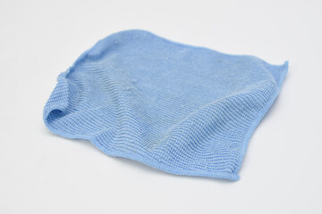 Blue microfiber cleaning cloth isolated on white background, concept of hygiene, household cleaning, and multipurpose fabric tool.
