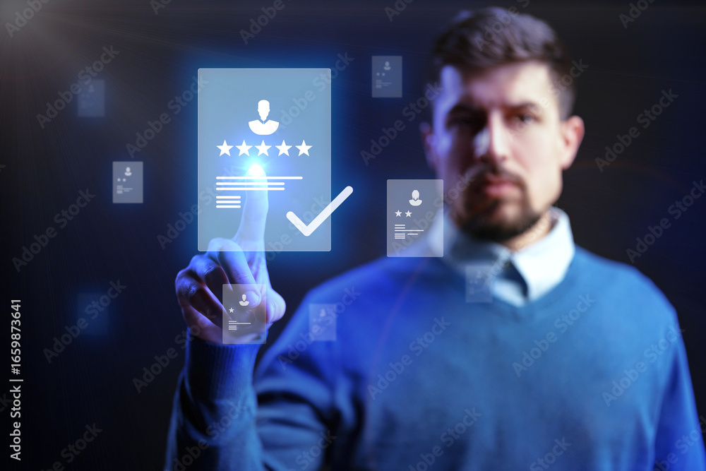 Poster Man using futuristic interface to access digital profiles and ratings in a dark studio setting during a tech demonstration