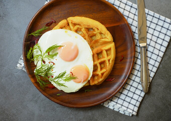Waffles, bread and fried eggs with vegetables, breakfast