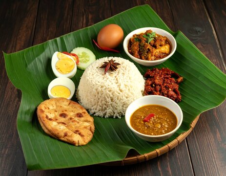 Fragrant nasi dagang with gulai ikan tongkol, pickled vegetables, boiled egg, served