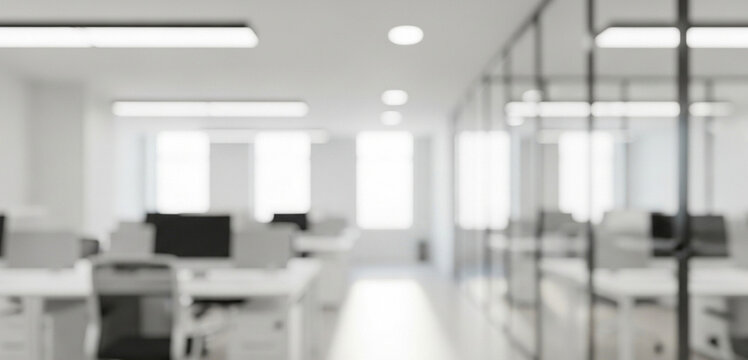 Blurred office interior featuring desks, computers, and sleek glass partitions in a brightly lit modern workspace, emphasizing an organized layout suitable for collaborative business activities.