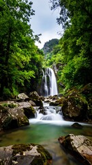 Naklejka premium Lush waterfall cascading through a verdant valley
