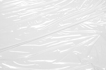 Obraz premium plastic overlay texture of realistic crumpled transparent plastic film wrap on white background,wrinkled stretched plastic effect.abstract plastic background on transparent png