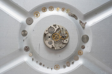 Pocket watch mechanism. Mechanical steel clockwork with cogwheel and screw