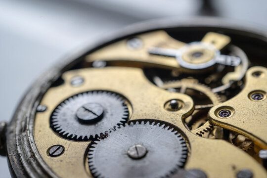Pocket watch mechanism. Mechanical steel clockwork with cogwheel and screw