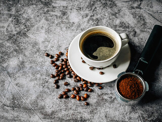 Coffee cup and beans with ground coffee on Portafilter,Top view Espresso coffee cup aromatic and making equipment