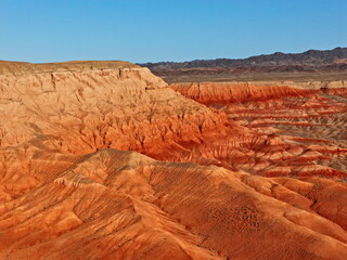 The Red Mountains of Boguta. Mountainous clay terrain. The view from the drone. Summer evening time. National Nature Park.