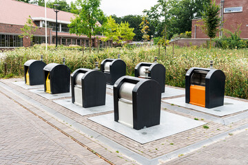 Underground Waste Containers: A row of bins in a town square, blending into the landscape.