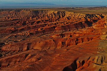 The Red Mountains of Boguta. Mountainous clay terrain. The view from the drone. Summer evening...