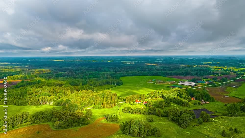 Aufkleber lush green forests and fields under clouds casting shadows, creating a dynamic natural landscape.