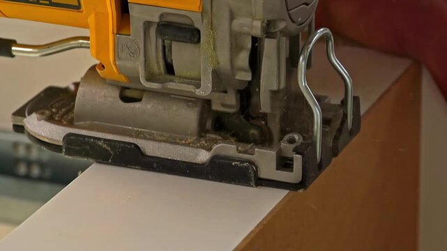Jigsaw in action, cutting through material with precision during a woodworking or construction task.