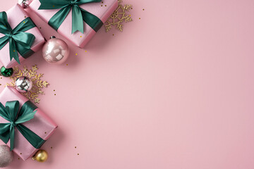 Elegant arrangement of wrapped gifts, festive ornaments, and decorative elements on a soft pink...