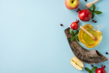 Rosh Hashanah Jewish holiday arrangement featuring honey, apples, pomegranates, and a shofar on a...