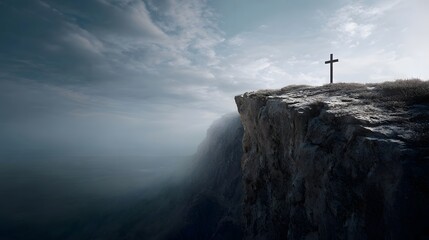 Fototapeta premium A lone cross stands atop a rugged cliff overlooking a vast atmospheric landscape