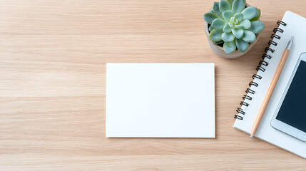 blank postcard mockup on a light wood desk with succulent plant spiral notebook and mobile phone clean modern minimalist workspace setting ideal for stationery invitations or branding