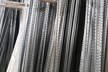 Metal rods displayed in a warehouse ready for use in various construction projects during daytime...