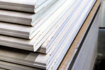 Detailed view of stacked construction panels in a workshop ready for interior projects and...