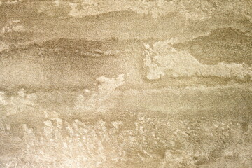 Textured beige wall with subtle patterns suggesting natural elements and organic shapes in a modern interior setting