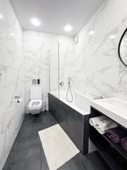 Bathroom. Luxury bathroom interior, white marble walls and grey floor. Modern interior.
