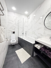Bathroom. Luxury bathroom interior, white marble walls and grey floor. Modern interior.