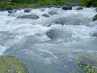 River with rocks streaming wild along a mountain, Jotunheimen National Park, Norway
