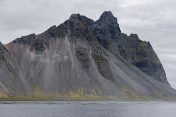 Scenic view of Vestrahorn mountain with overcast sky.