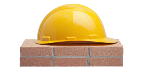 Yellow safety helmet on bricks construction concept isolated on white transparent background