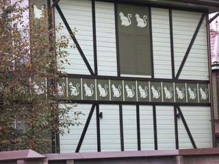 Fototapeta premium funny house with silhouettes of cats on the facade