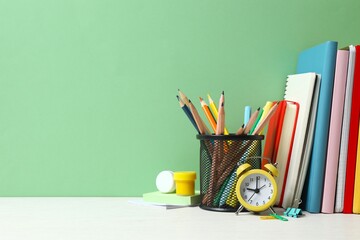 A back to school concept featuring various school supplies and notebooks