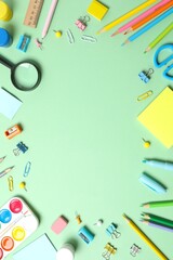 Back to school concept. Top view with school supplies on green background
