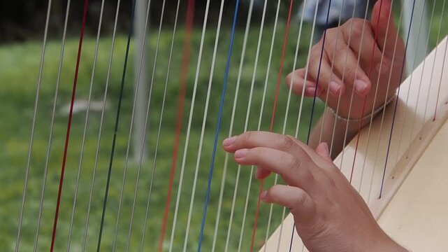 Harp, detail of hands playing slow motion