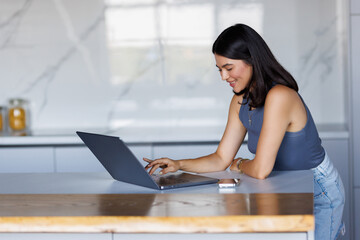 Young pretty woman working at home in the morning